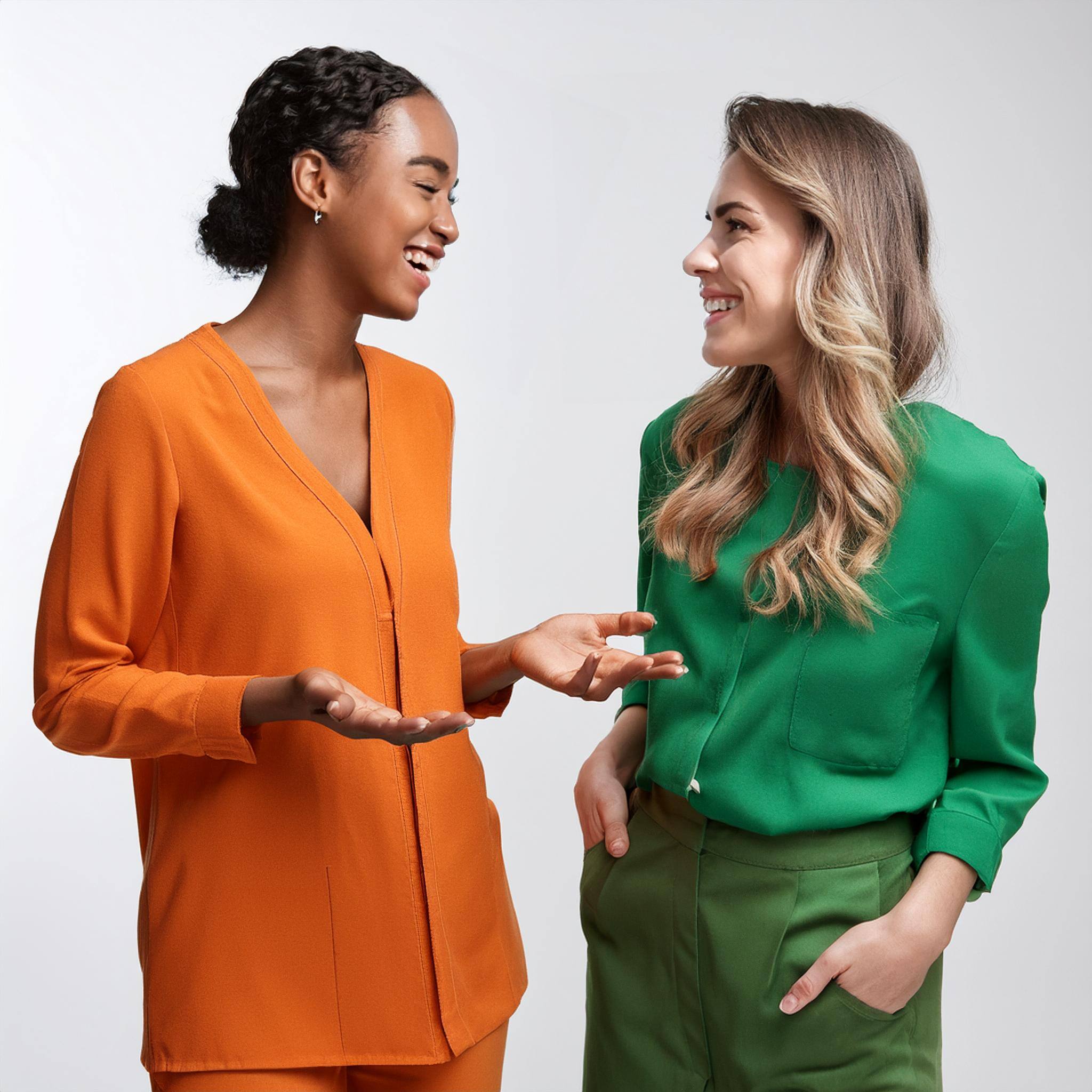 Firefly two happy hr people having a conversation wearing green and orange clothes white background 